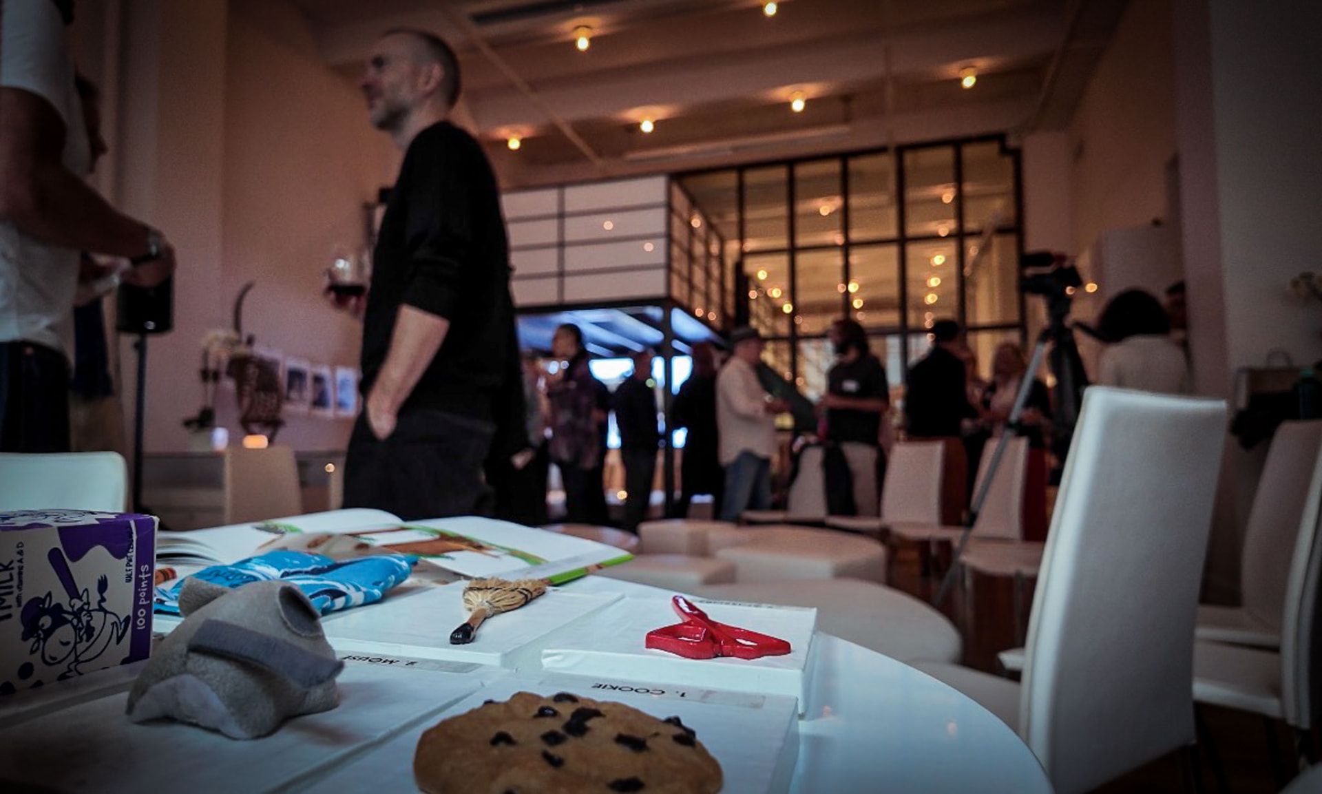 A guest photographing objects laid out on a table